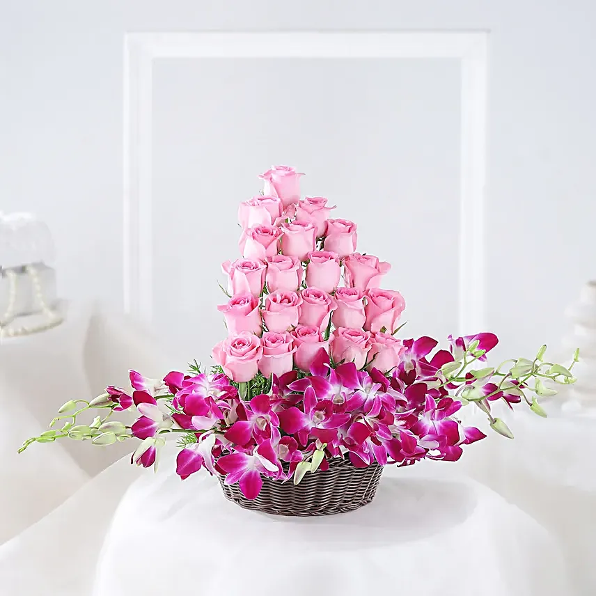 Cane Basket arrangement of 20 pink roses and 6 purple orchids