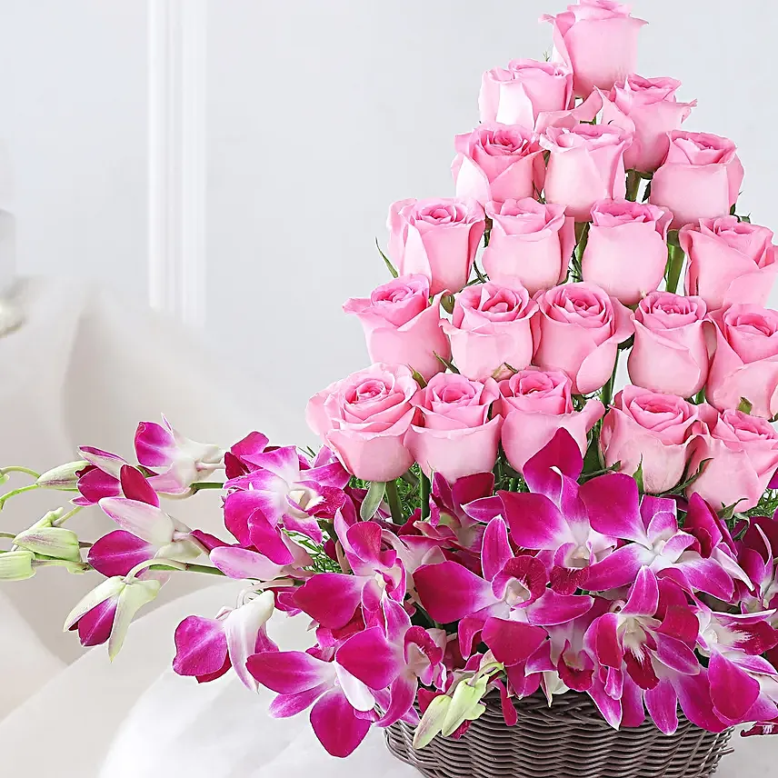 Cane Basket arrangement of 20 pink roses and 6 purple orchids