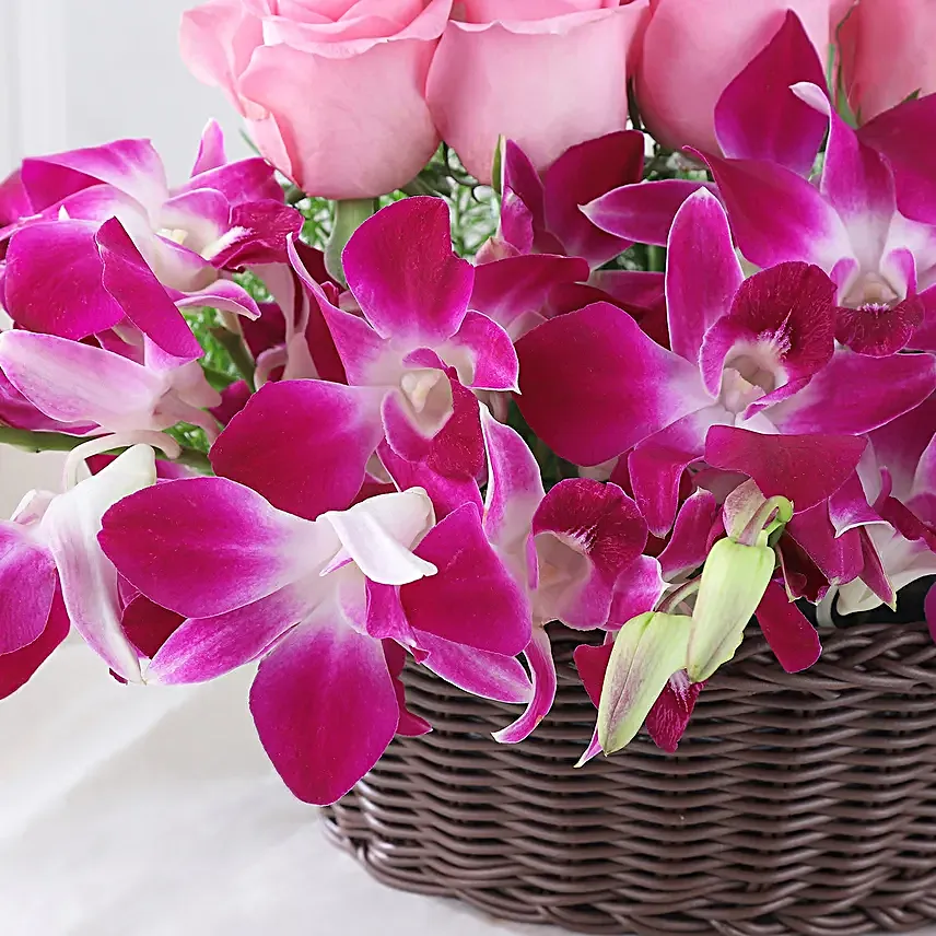 Cane Basket arrangement of 20 pink roses and 6 purple orchids