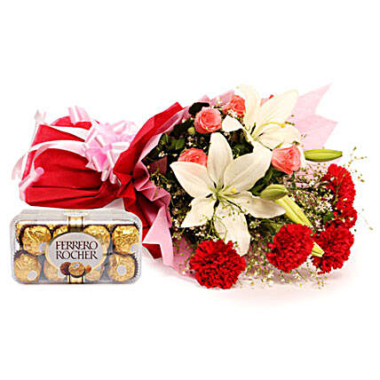 Sweetest Of All - Bunch of 2  Asiatic Lilies, 5 Red Carnations and 5 Pink Roses in a two layer paper packing and 200 grams Ferrero Rocher chocolates.