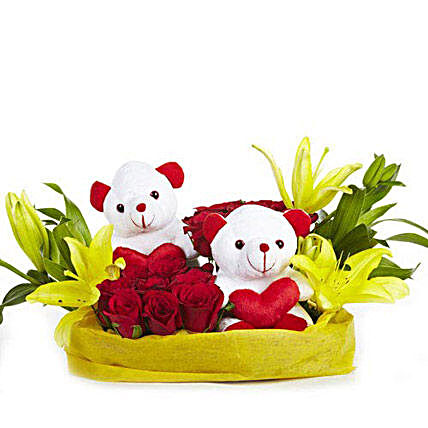 You N Me - Basket arrangement of 12 Red roses with 2 cute soft toys, 2 yellow Asiatic lilies wrapped in paper packing.