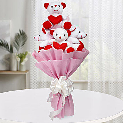 A bouquet of five red and white teddy bears wrapped with pink paper packaging and white ribbon:Soft Toys for Birthday