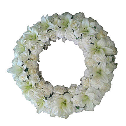 A fresh flower wreath with white roses, white carnations and white asiatic lilies:Sympathy Flowers