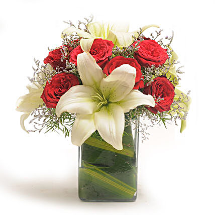 Roses N Lilies - Glass vase arrangement of 10 red roses with 2 lilies.