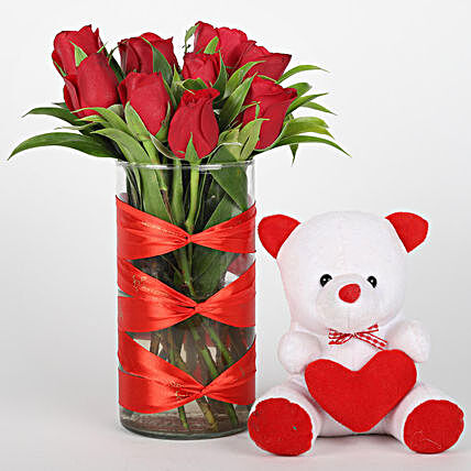 Elegant roses in vase with teddy bear for her