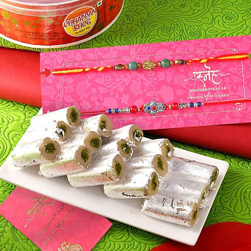 Set Of 2 Evil Eye Stone Rakhis And Pista Roll:Rakhi with Sweets to Malaysia