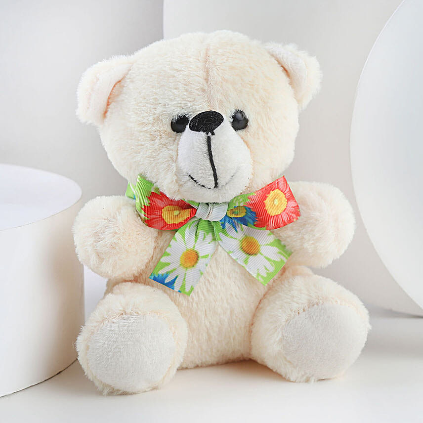 A hamper containing table top, dairy milk , cream teddy bear and a love message gifts