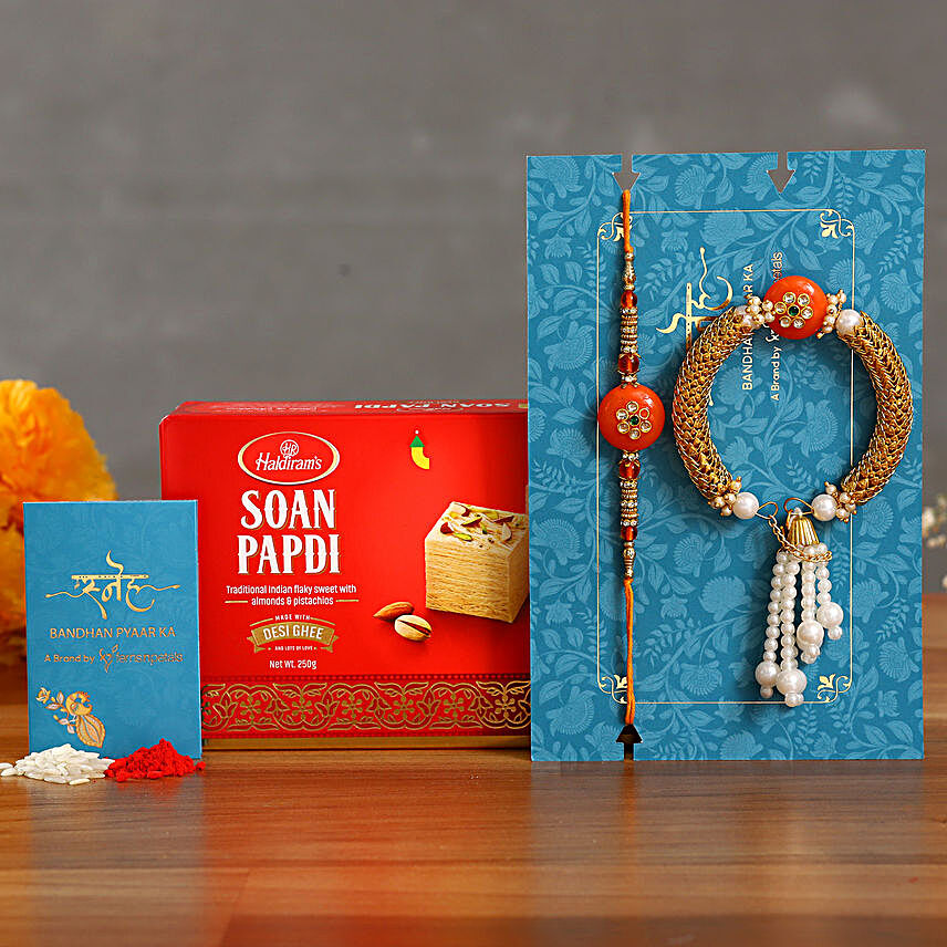 Orange Pearl And Lumba Rakhi Set With Soan Papdi:Set of 2 Rakhi to Qatar