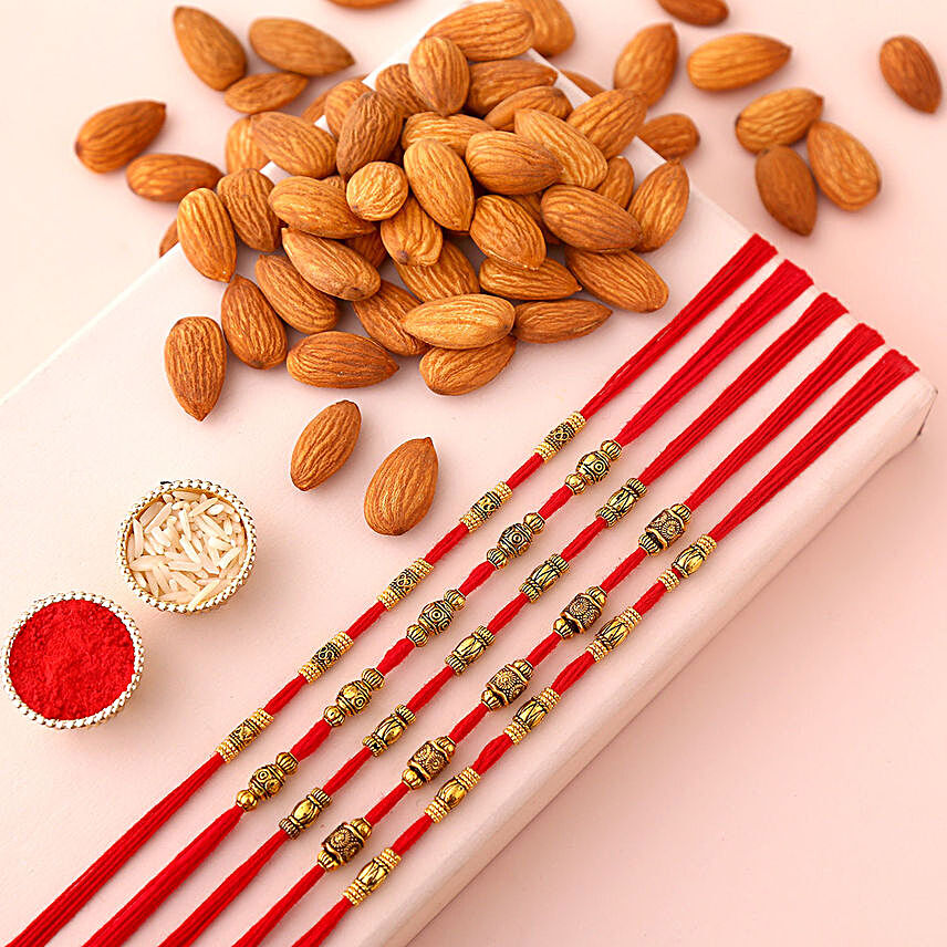 Sneh Brass Rakhi Set & Almonds:Rakhi and Dryfruits to Qatar