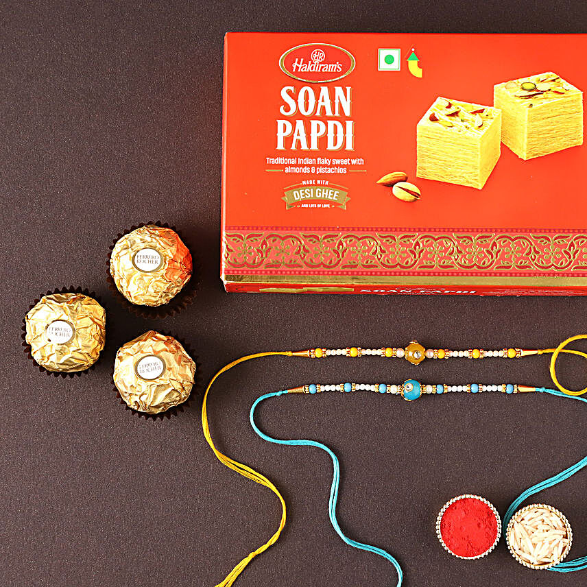 Sneh Pearl Rakhis With Soan Papdi & Chocolates:Rakhi and Chocolates to Qatar