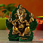 Divine Raja Ganesha Idol On Green Leaf Throne