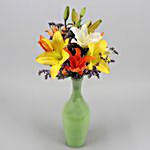 Mixed Asiatic Lilies In Green Glass Vase