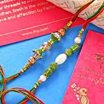 2 Floral Green Pearls Rakhis & Assorted Chikki Hamper
