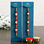 Two Pearl Rakhis With Money Plant Combo