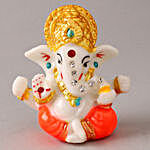 4 Swastik Diyas & Ganesha Idol With Kaju Katli
