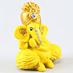 Yellow Ganesha Idol & Motichoor Laddoo With Diyas
