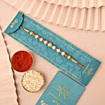 Sneh Pearl and Gold Rakhi Set with Money Plant