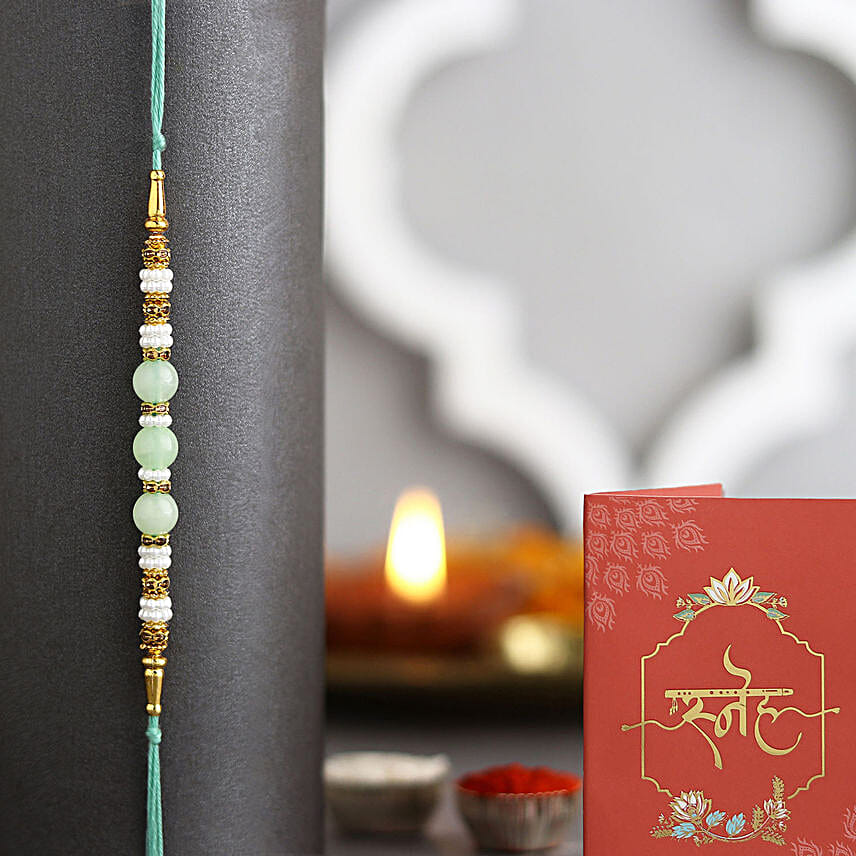 Striking Mixed Flowers Round Basket With Green Pearl Rakhi