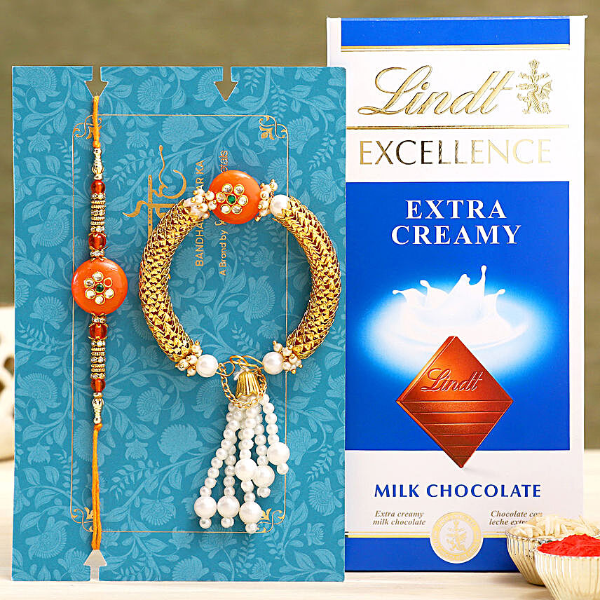 Orange Pearl And Lumba Rakhi Set With Lindt:Rakhi and Chocolates to Dubai