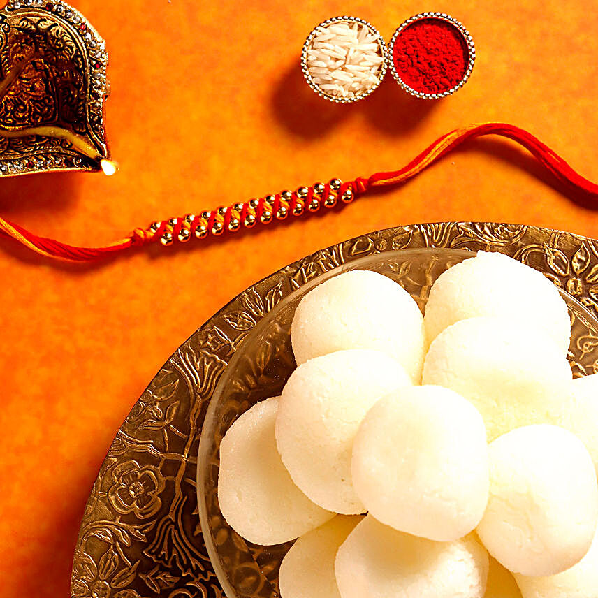 Sneh Gold Mauli Rakhi with 1 Kg Rasgulla Tin:Rakhi With Sweets to UAE