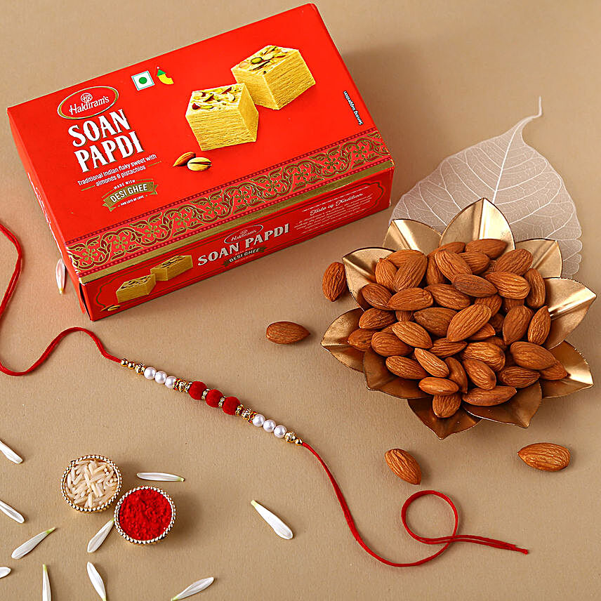 White Pearl And Velvet Beads Rakhi with 250 Grams Soan Papdi and Almonds:Rakhi With Dry fruit Hampers