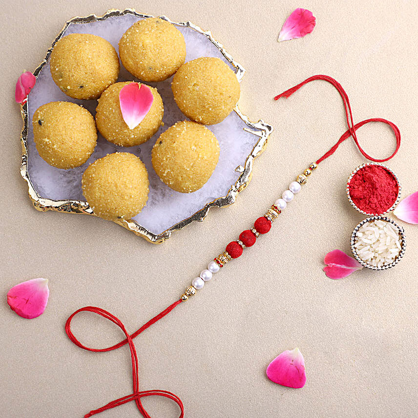 White Pearl And Velvet Beads Rakhi with 500 grams Besan Ladoo:Rakhi With Sweets to UAE
