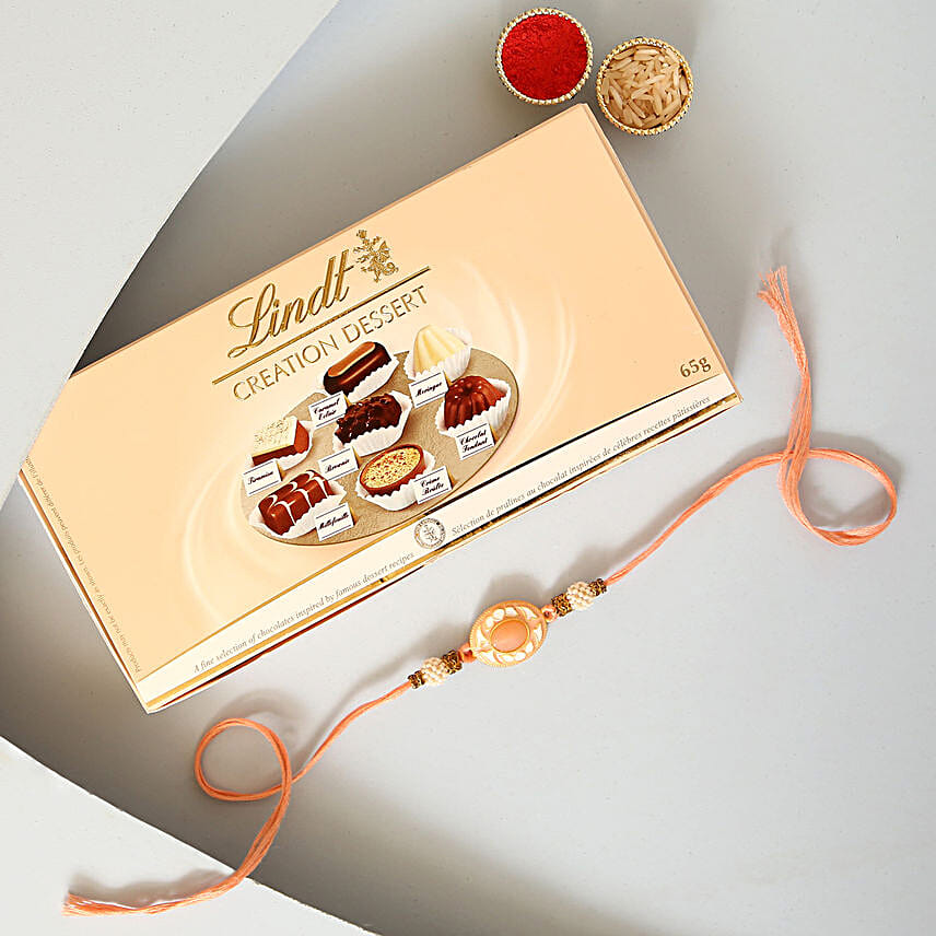 Sneh White Pearls Rakhi & Lindt Creation Dessert