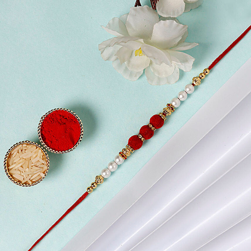 Sneh White Pearls Rakhi & Lindt Creation Dessert