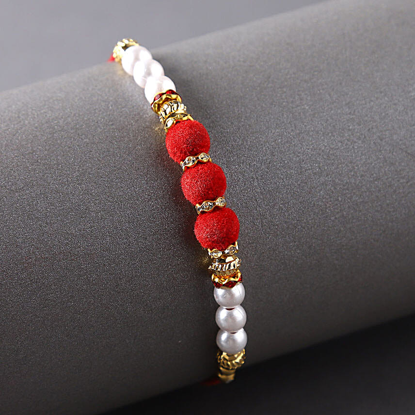 Sneh White Pearls Rakhi & Lindt Creation Dessert