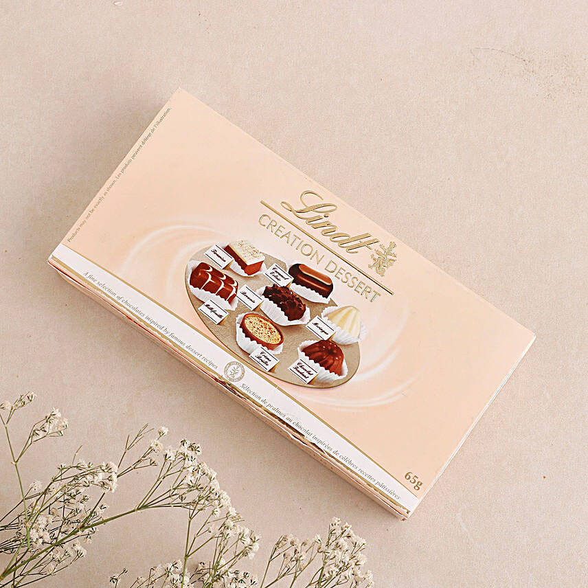 Sneh White Pearls Rakhi & Lindt Creation Dessert
