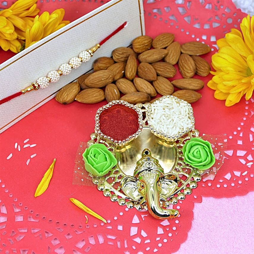 White Pearl Rakhi And Ganesha Pooja Thali With Almonds