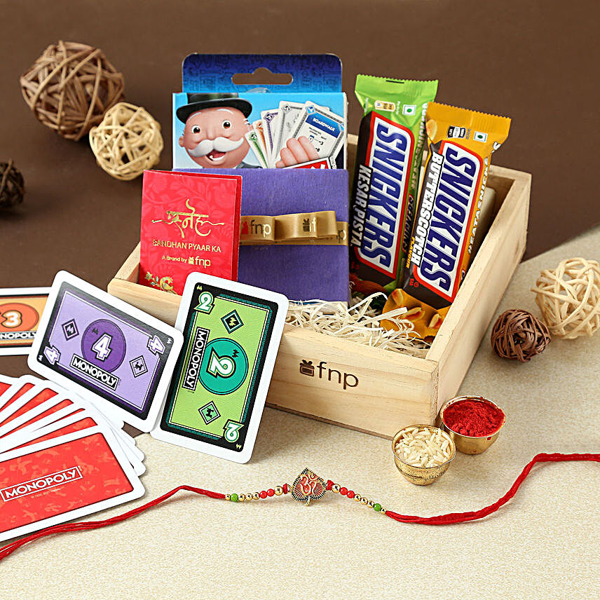 Sneh Leaf Om Rakhi With Snickers N Monopoly Game:Rakhi With Gift Hampers to USA