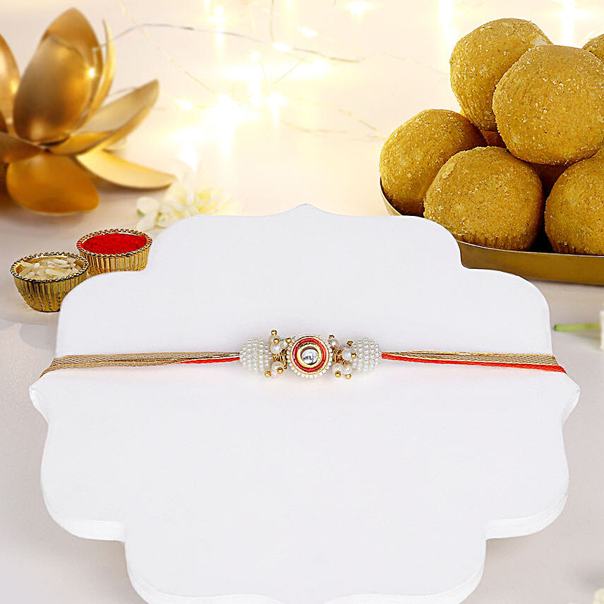 Crimson Majestic Pearl Rakhi N Besan Laddoo Delight